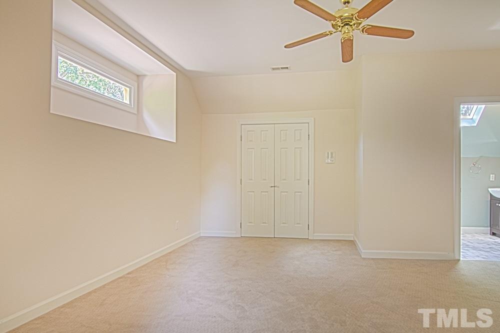7612 Rainwater Road Raleigh, NC 27615 - Photo 22 of 22 an empty room with a window and a fan