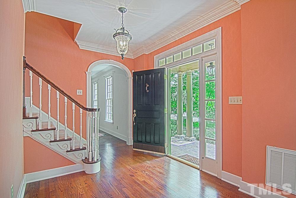 7612 Rainwater Road Raleigh, NC 27615 - Photo 4 of 22 a view of a room with wooden floor windows and entryway