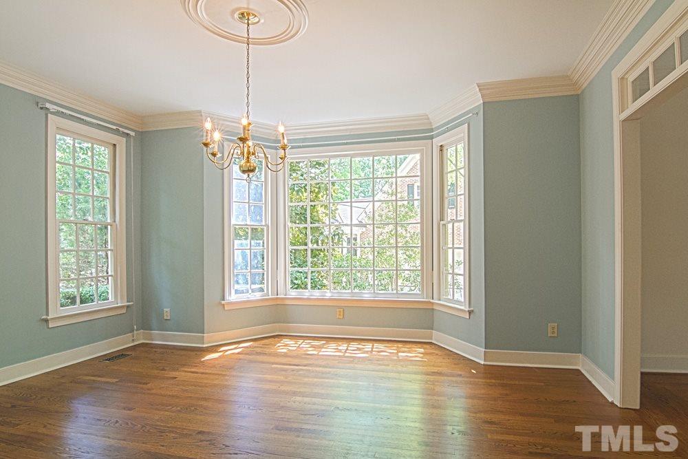 7612 Rainwater Road Raleigh, NC 27615 - Photo 6 of 22 a view of an empty room with wooden floor and a window