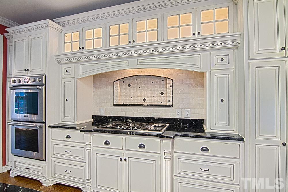 7612 Rainwater Road Raleigh, NC 27615 - Photo 8 of 22 a close view of a stove top oven with granite countertop cabinets