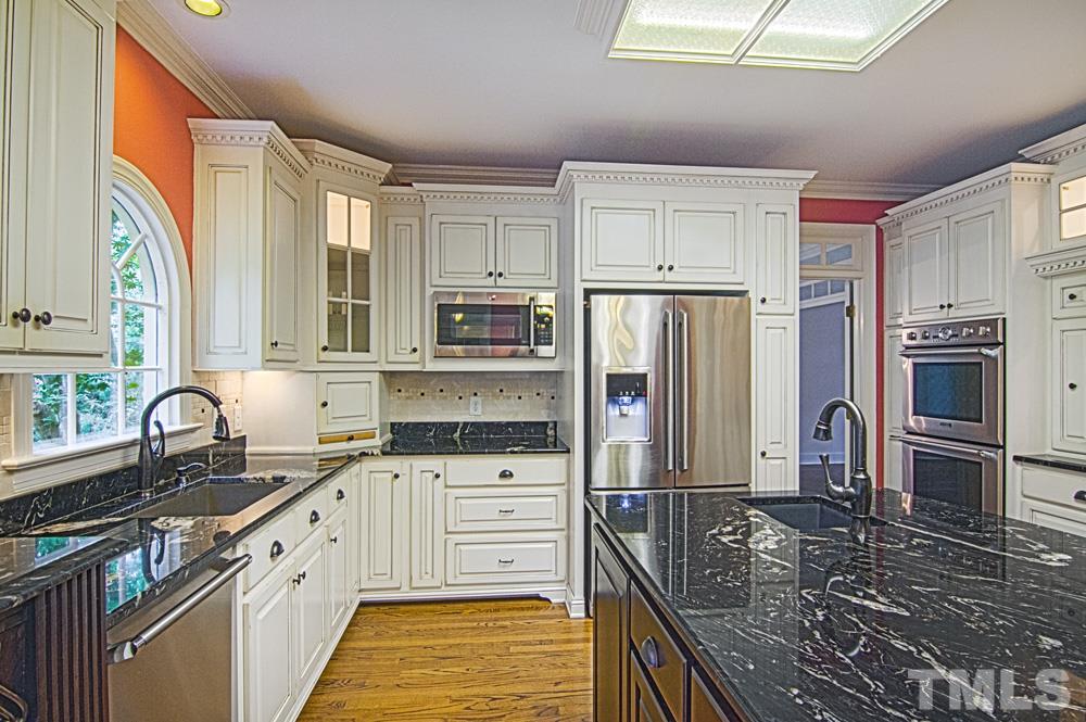 7612 Rainwater Road Raleigh, NC 27615 - Photo 9 of 22 a kitchen with stainless steel appliances a refrigerator sink and cabinets