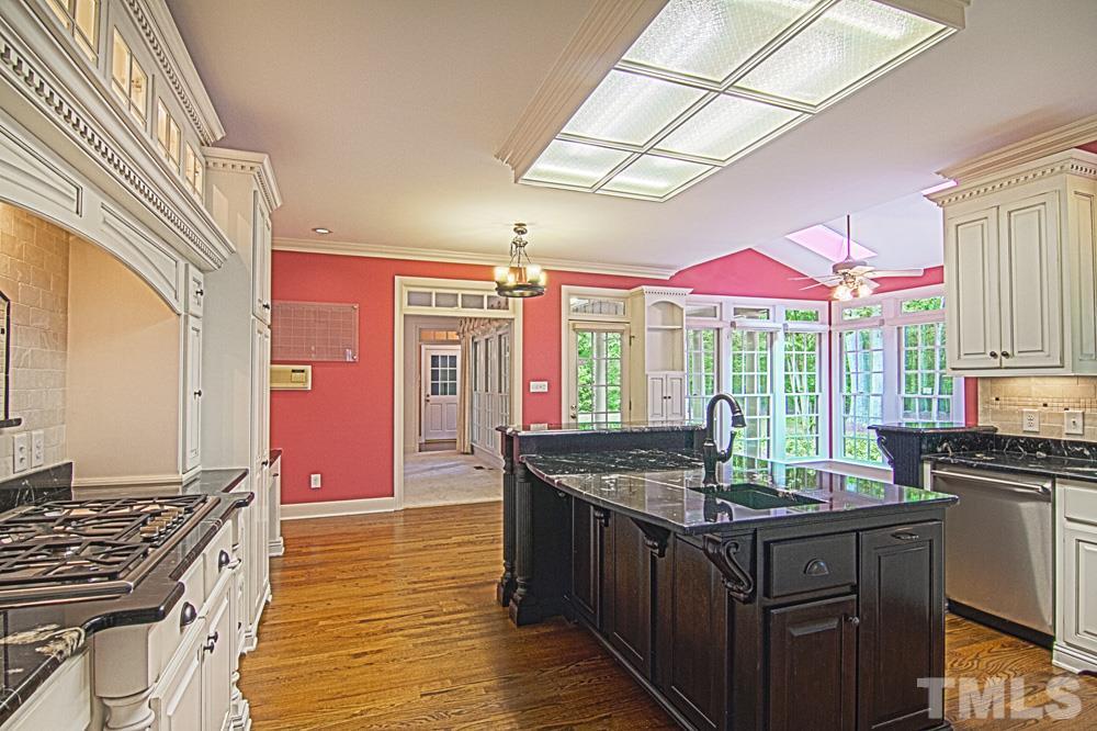 7612 Rainwater Road Raleigh, NC 27615 - Photo 10 of 22 a kitchen with granite countertop a sink stove and cabinets
