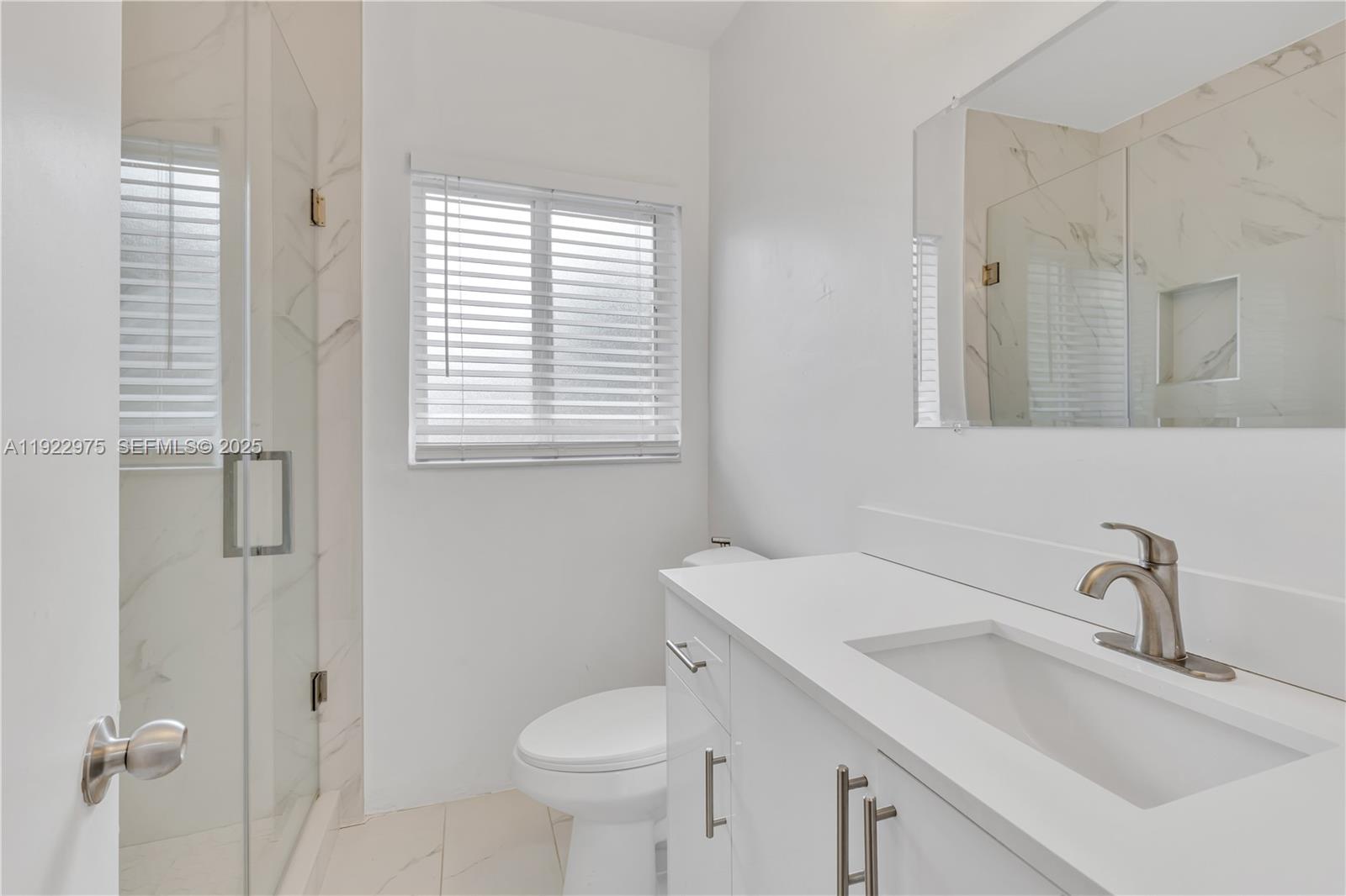 505 Southwest 11th Street, Unit 505 Miami, FL 33129 - Photo 18 of 31 a bathroom with a sink toilet and shower