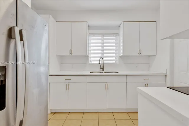 a kitchen with white cabinets and a sink