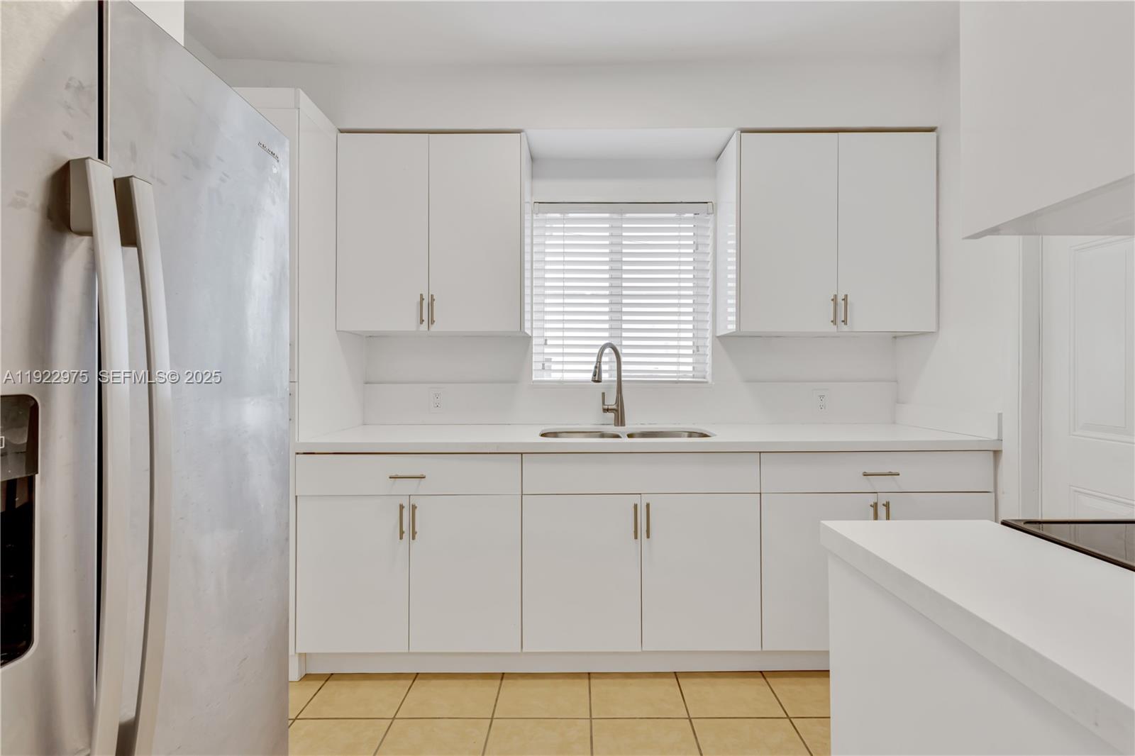 505 Southwest 11th Street, Unit 505 Miami, FL 33129 - Photo 2 of 31 a kitchen with white cabinets and a sink