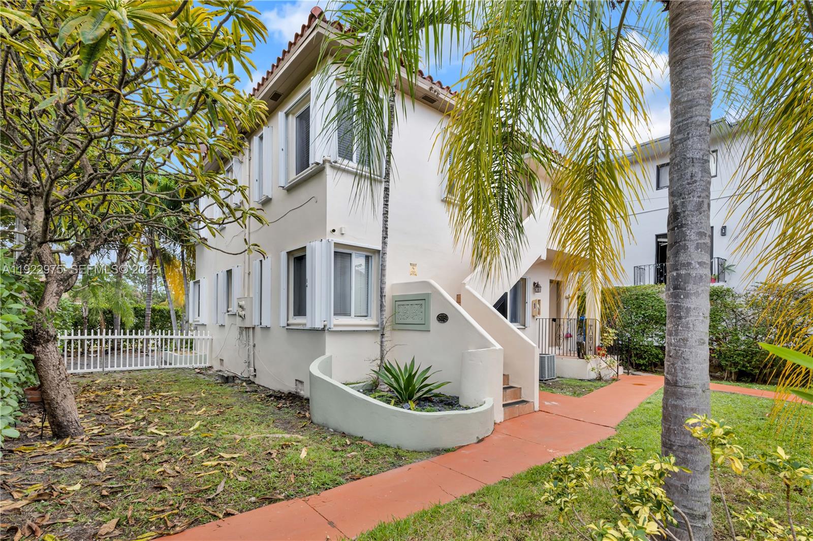 505 Southwest 11th Street, Unit 505 Miami, FL 33129 - Photo 30 of 31 a view of a house with a small yard and large trees