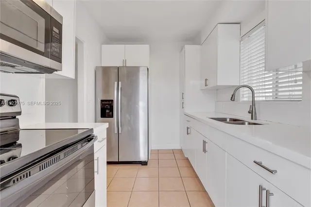 a kitchen with a sink stove and refrigerator