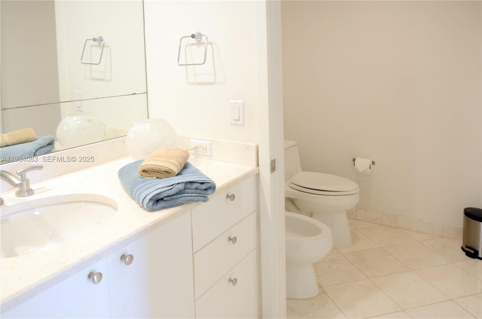 901 Brickell Key Boulevard, Unit 705 Miami, FL 33131 - Photo 14 of 41 a bathroom with a sink a toilet and shower