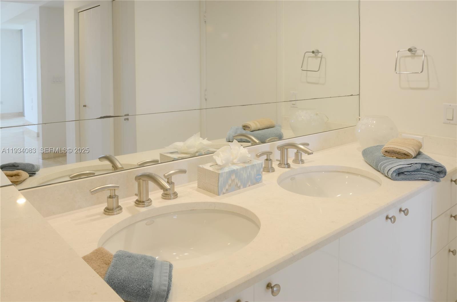 901 Brickell Key Boulevard, Unit 705 Miami, FL 33131 - Photo 15 of 41 a bathroom with a sink and a mirror