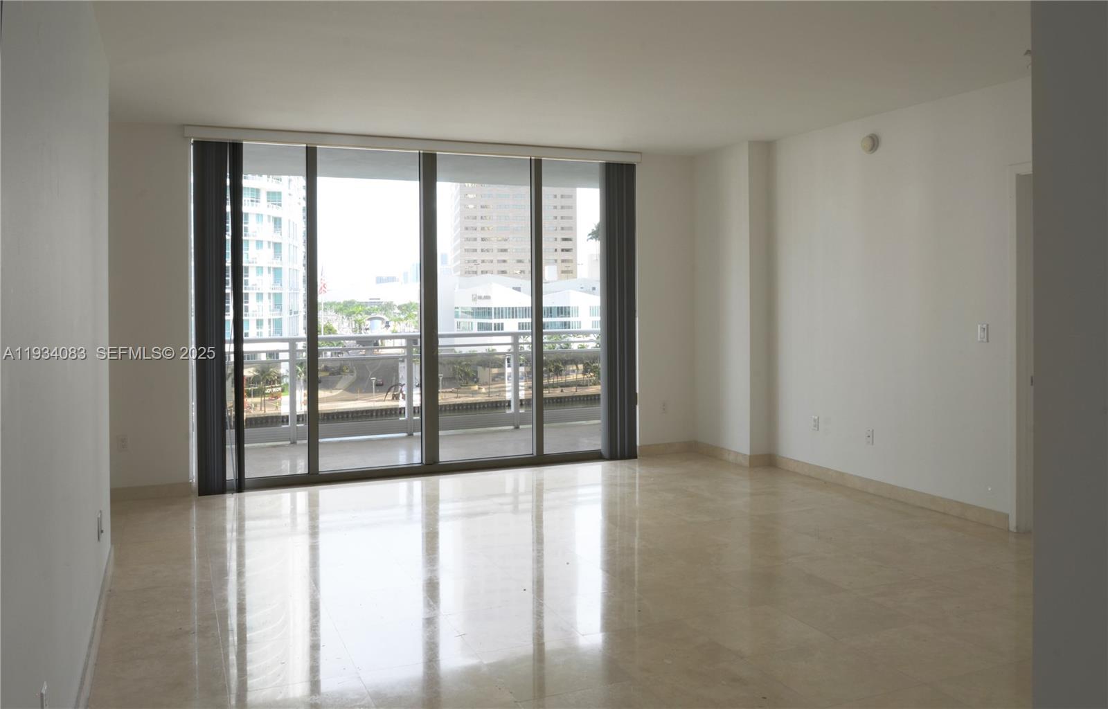 901 Brickell Key Boulevard, Unit 705 Miami, FL 33131 - Photo 2 of 41 a view of an empty room with glass windows