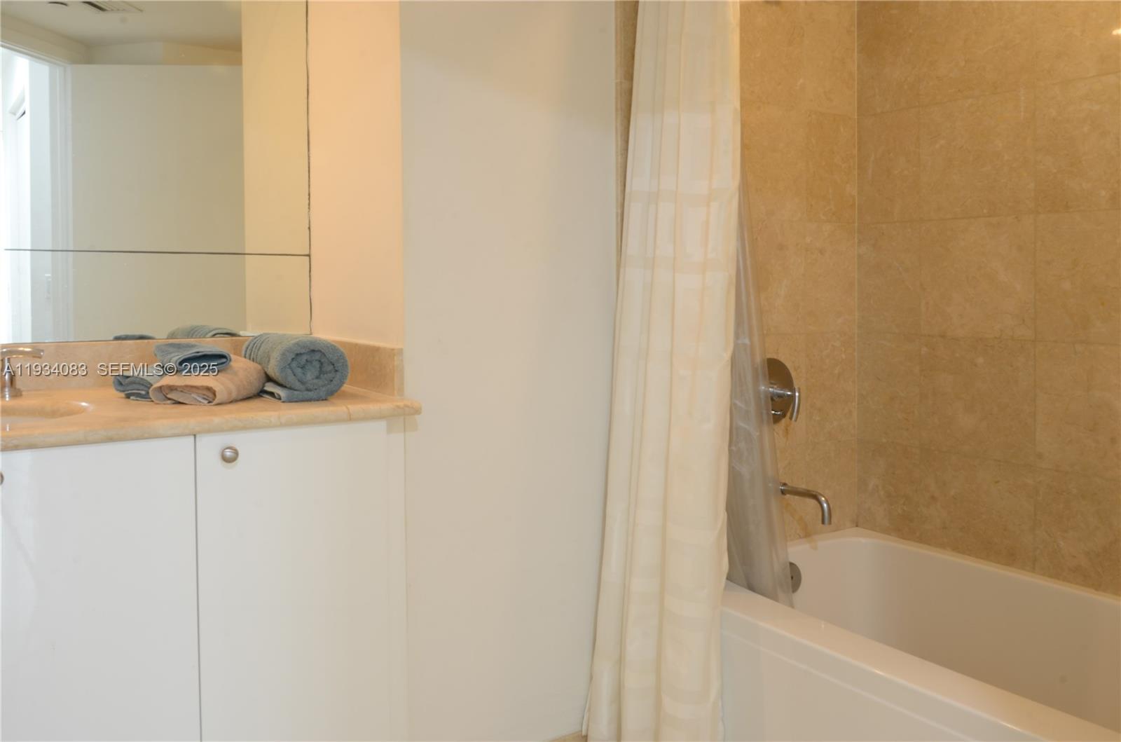 901 Brickell Key Boulevard, Unit 705 Miami, FL 33131 - Photo 23 of 41 a bathroom with a tub and sink