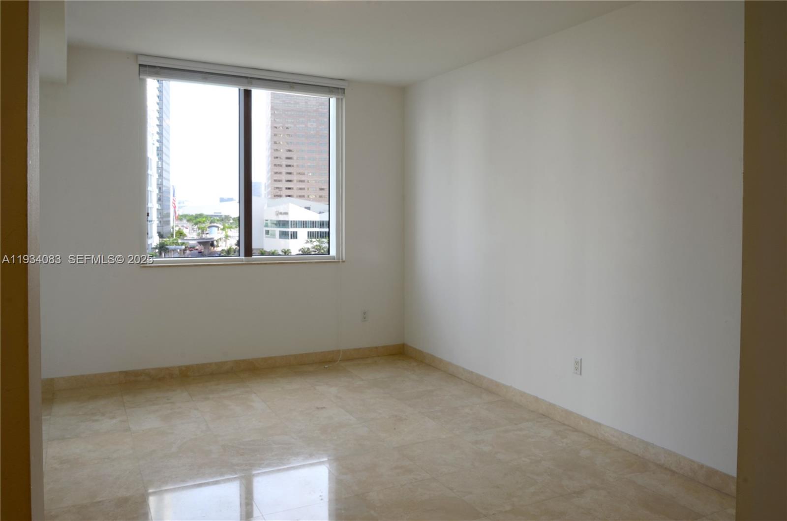 901 Brickell Key Boulevard, Unit 705 Miami, FL 33131 - Photo 6 of 41 an empty room with a window