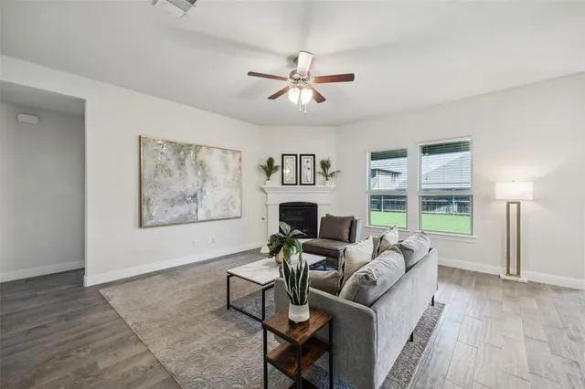 a living room with furniture a chandelier and a window