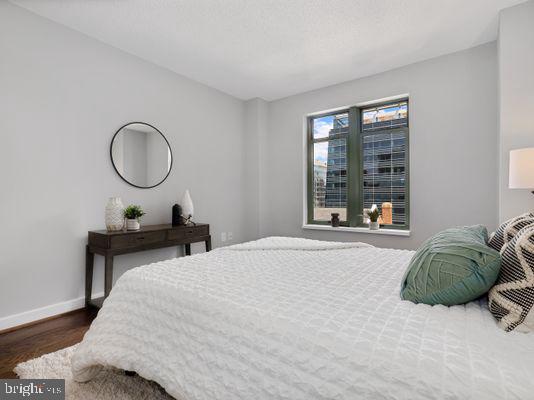 1150 K Street Northwest, Unit 709 Washington, DC 20005 - Photo 21 of 25 a bedroom with a bed and window