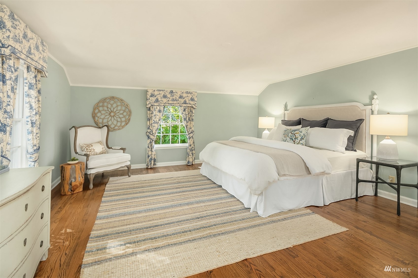 6560 Northeast Windermere Road Seattle, WA 98105 - Photo 22 of 35 a bedroom with a bed a couch and wooden floor