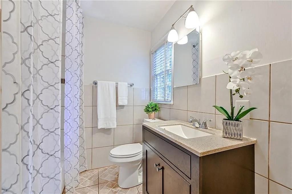 260 River Valley Road Northwest Atlanta, GA 30328 - Photo 14 of 20 a bathroom with a sink mirror and toilet