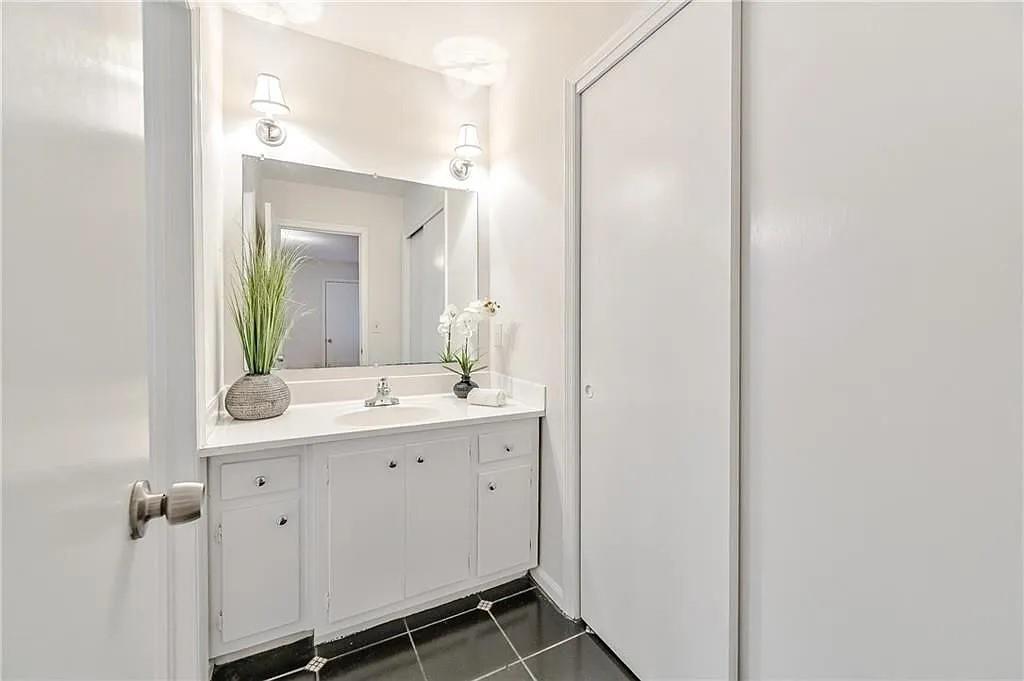 260 River Valley Road Northwest Atlanta, GA 30328 - Photo 17 of 20 a bathroom with a double vanity sink and mirror