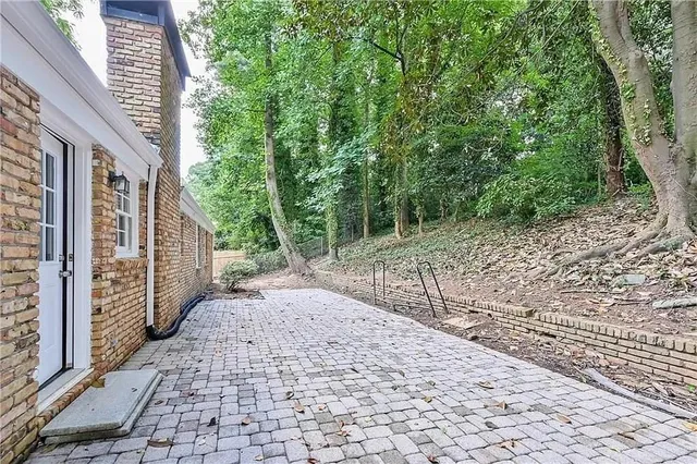 a pathway of a house with a yard
