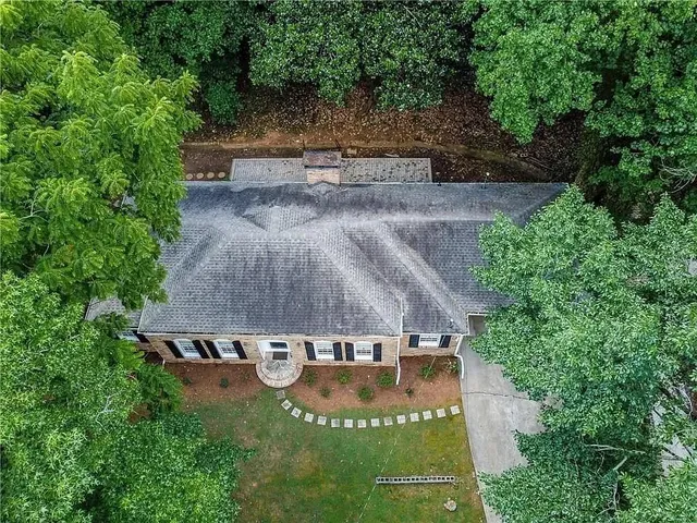 an aerial view of a house with yard basket ball court and outdoor seating