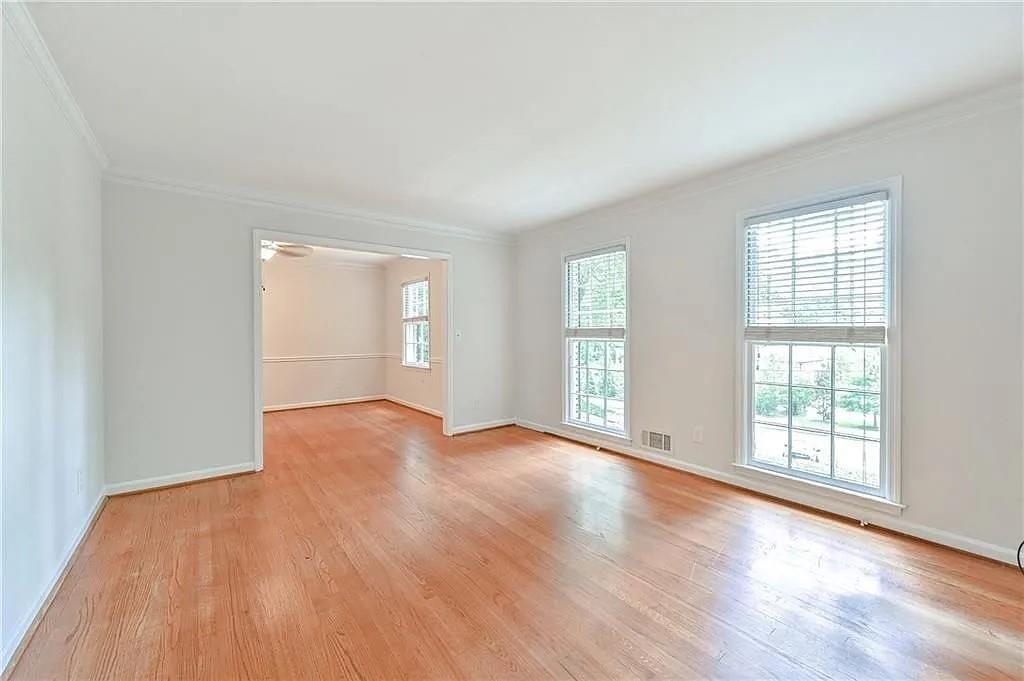 260 River Valley Road Northwest Atlanta, GA 30328 - Photo 3 of 20 an empty room with wooden floor and windows