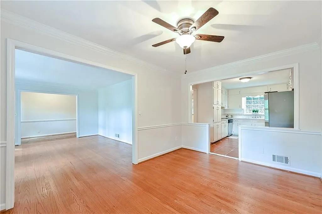 260 River Valley Road Northwest Atlanta, GA 30328 - Photo 4 of 20 a view of a livingroom with a ceiling fan wooden floor and a kitchen