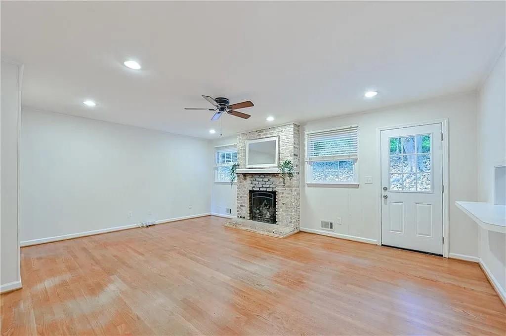 260 River Valley Road Northwest Atlanta, GA 30328 - Photo 6 of 20 an empty room with windows and fireplace