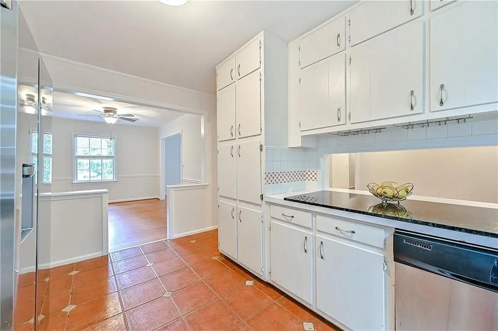 260 River Valley Road Northwest Atlanta, GA 30328 - Photo 9 of 20 a kitchen with granite countertop white cabinets and white appliances
