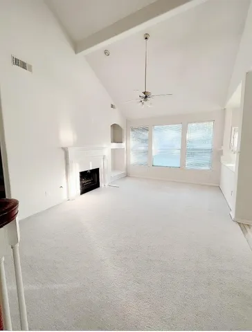 a view of a livingroom with a fireplace and window