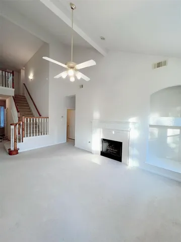 a view of a livingroom with a ceiling fan and a rug