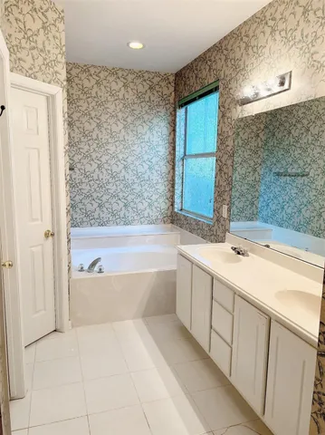 a bathroom with a bathtub and a sink