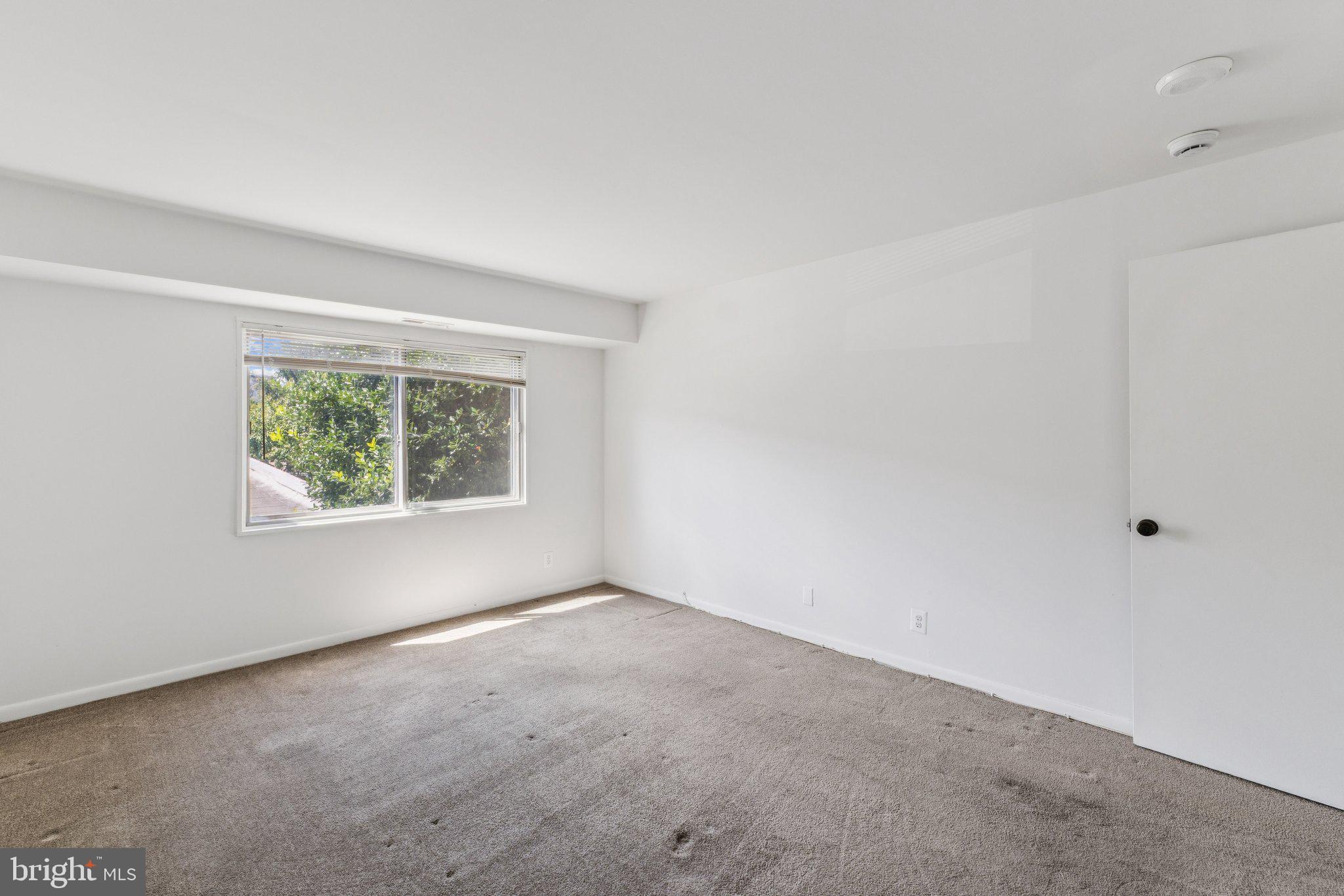12001 Old Columbia Pike, Unit 209 Silver Spring, MD 20904 - Photo 13 of 27 an empty room with windows