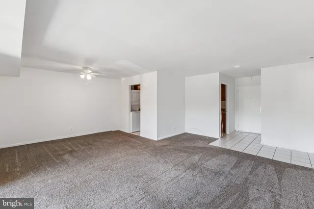 a view of an empty room with a kitchen
