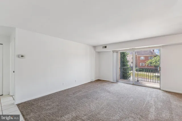 a view of an empty room with glass door