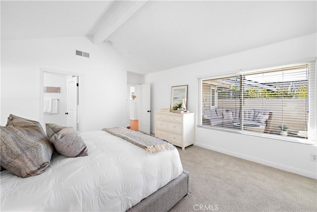 a spacious bedroom with a large bed and a large window