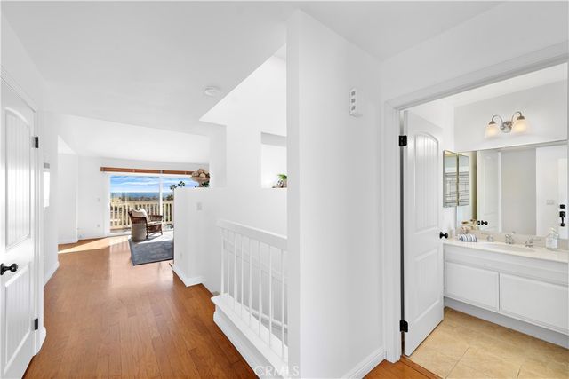 a view of a hallway view with wooden floor and living room