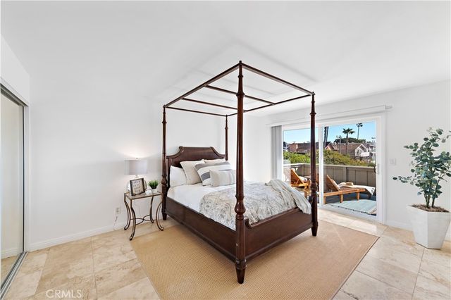 a bedroom with a bed lamp and a window