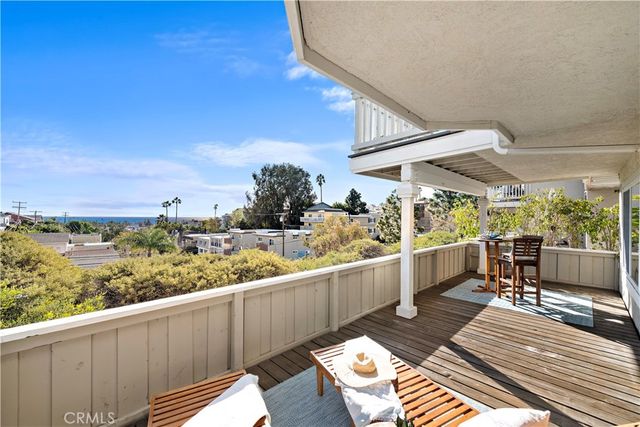 a view of balcony with wooden floor and outdoor seating
