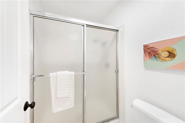 a bathroom with a shower and a toilet