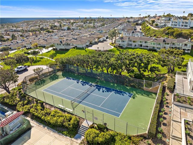an aerial view of a residential building with swimming pool