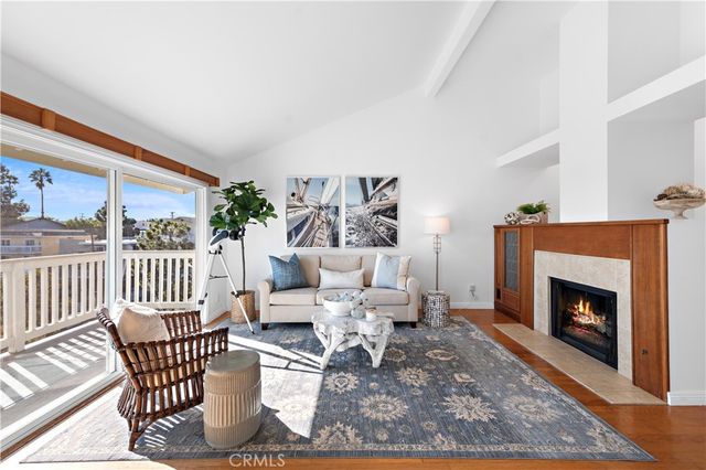 a living room with furniture a rug and a fireplace