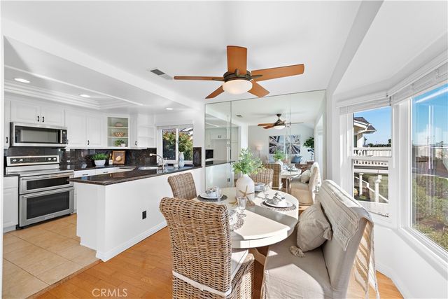 a kitchen with stainless steel appliances kitchen island granite countertop a sink and cabinets