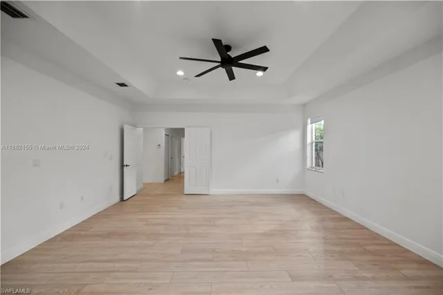 a view of empty room with ceiling fan
