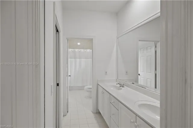a bathroom with a double vanity sink and mirror