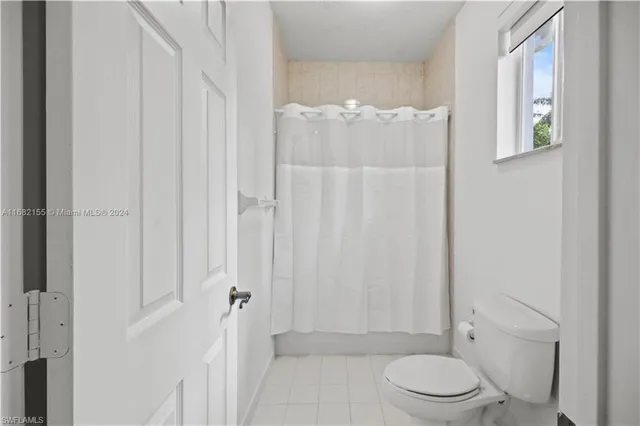 a bathroom with a toilet a sink and shower