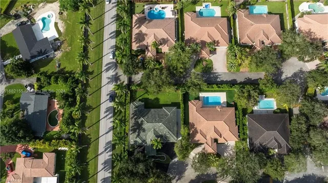 an aerial view of a house with a yard and lake view