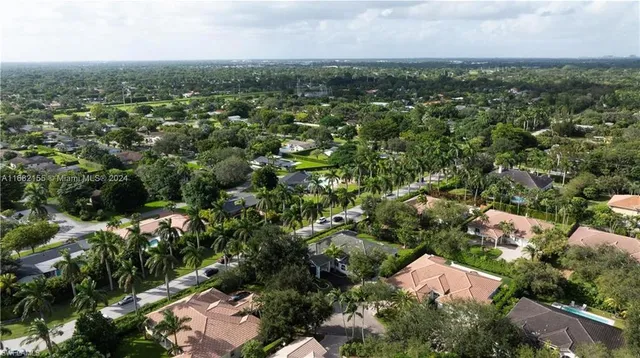 an aerial view of residential houses with city view