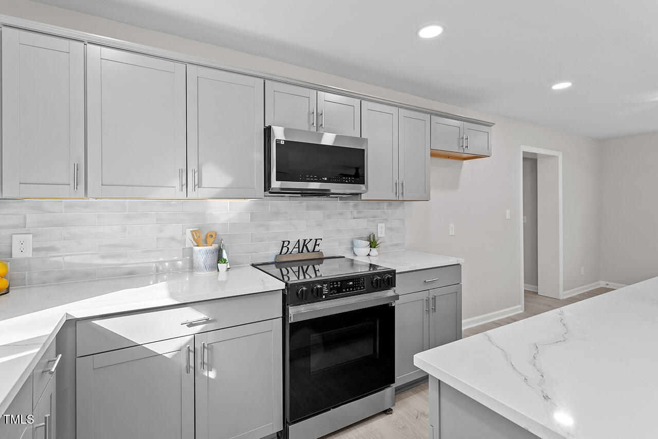 1014 Southerlund Road Garner, NC 27529 - Photo 11 of 36 a kitchen with a sink stove and microwave