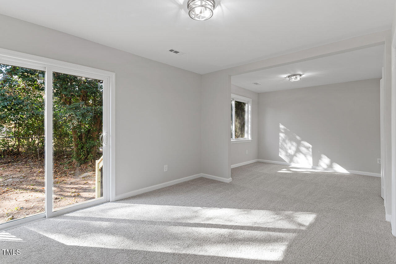 1014 Southerlund Road Garner, NC 27529 - Photo 19 of 36 a view of empty room with wooden floor and fan