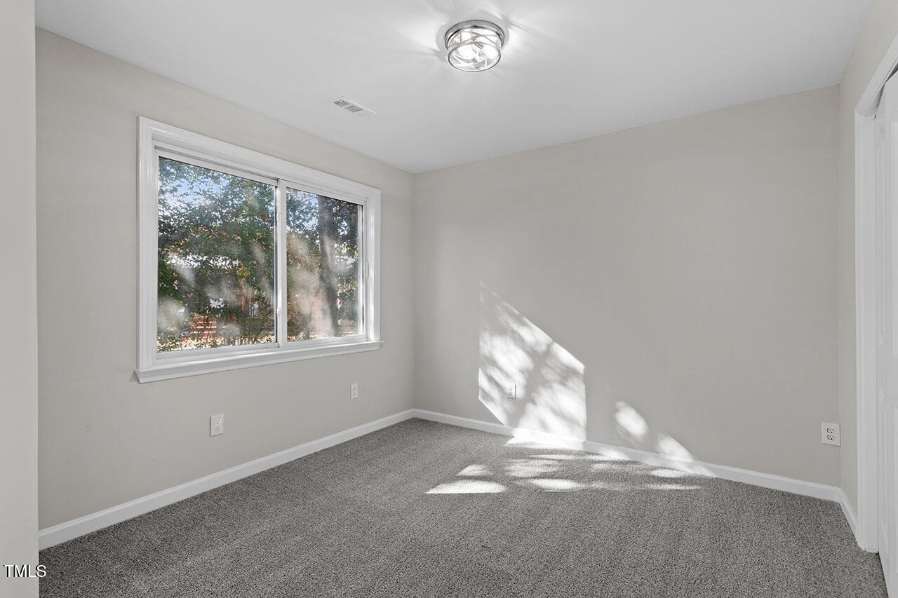 1014 Southerlund Road Garner, NC 27529 - Photo 22 of 36 a view of empty room with wooden floor and fan