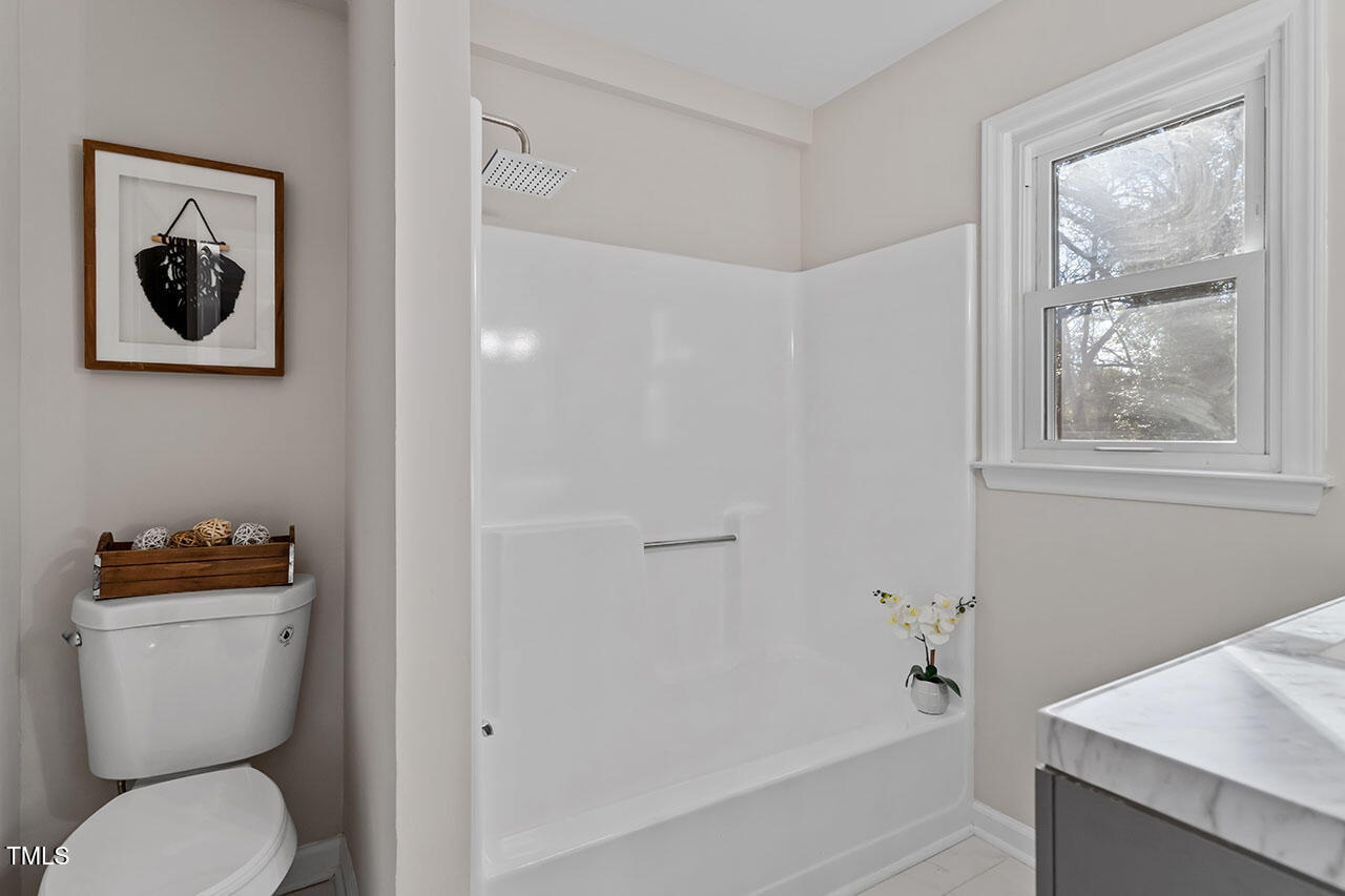 1014 Southerlund Road Garner, NC 27529 - Photo 27 of 36 a white toilet sitting next to a bath tub